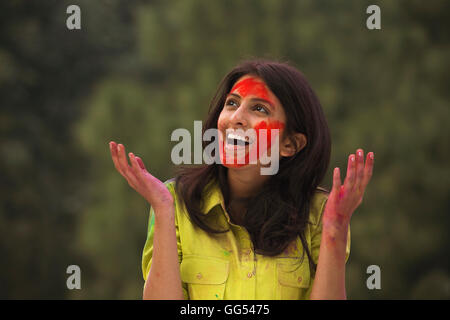 Womans face covered in holi colours Stock Photo