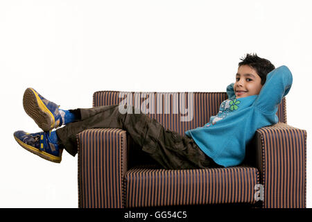 A boy lying on a sofa Stock Photo