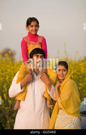 Happy indian family of farmer in agricultural field Stock Photo - Alamy