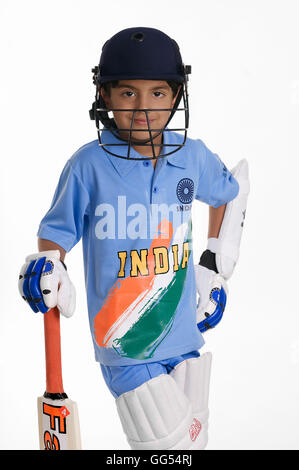 A boy in a cricketer's outfit Stock Photo