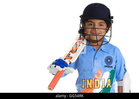 A boy in a cricketer's outfit Stock Photo