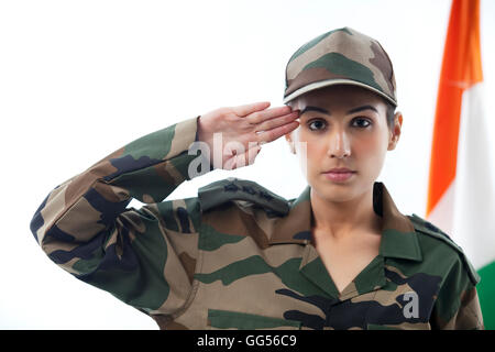 Female soldier saluting with Indian flag in background Stock Photo