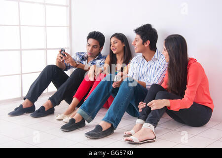 Full length of college friends spending leisure time in college Stock Photo