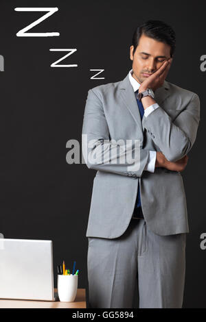 Digitally generated image of young businessman sleeping in office Stock Photo