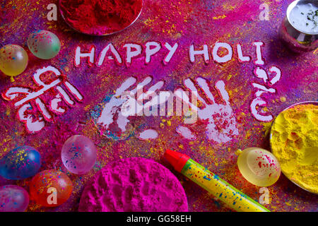 Squirt gun, water bombs and colorful Holi power on rangoli Stock Photo