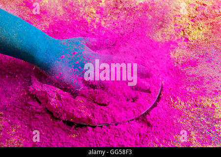 Close-up of hand splashing pink powder paint during Holi festival Stock Photo