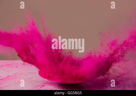 Pink color powder splashing during Holi festival Stock Photo