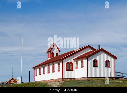 Red and white wooden church designed by local carpenter Pavia Høegh in1927. Narsaq, Kujalleq, Southern Greenland Stock Photo