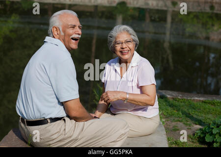 Cheerful couple having fun at park Stock Photo