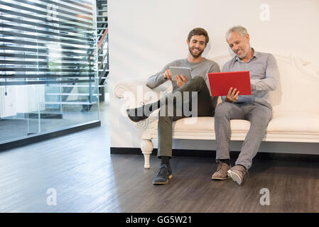 Design professionals using digital tablet in an office Stock Photo