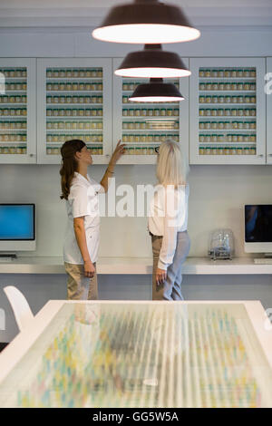 Female pharmacists discussing in pharmacy Stock Photo