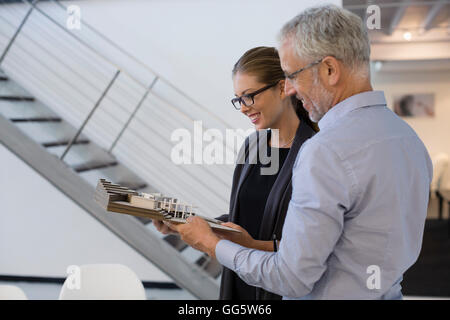 Design professionals examining architectural model in an office Stock Photo