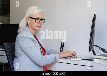Businesswoman working on a computer in the office Stock Photo