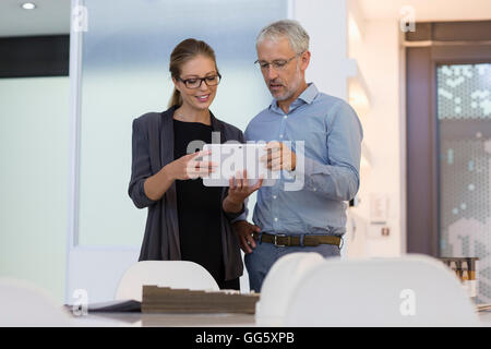 Design professionals using a digital tablet in an office Stock Photo