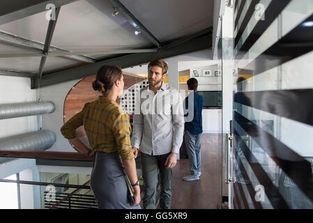 Business coworkers talking in an office Stock Photo