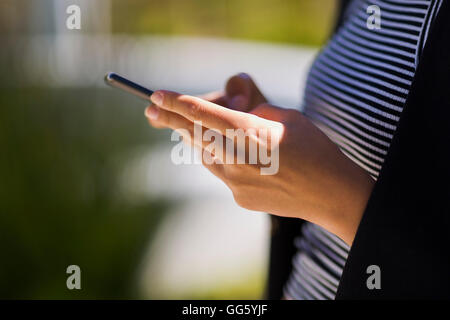 Midsection view of a woman using a smart phone Stock Photo
