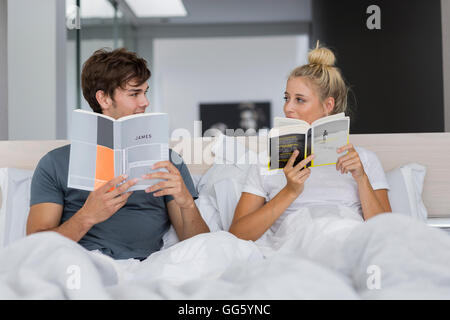 Happy young couple reading books Stock Photo