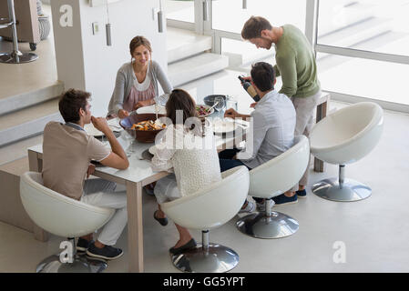 People sitting at dining table Stock Photo