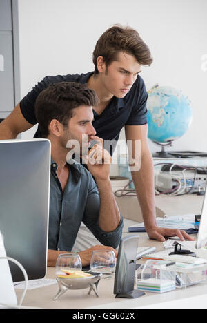 Two business executives working on computer in office Stock Photo