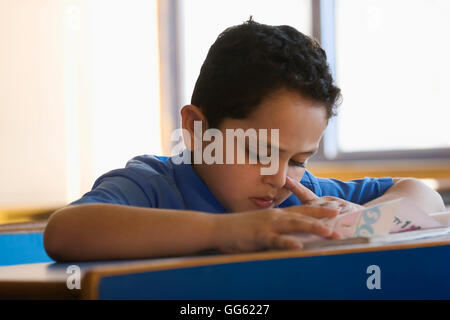School boy at his desk Stock Photo