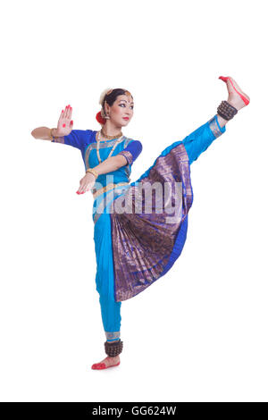 Full length of dancer performing Bharatanatyam against white background Stock Photo