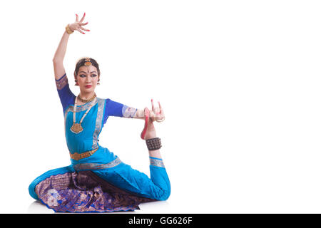 Full length of woman performing Bharatanatyam against white background Stock Photo