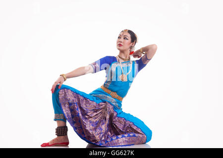 Full length of dancer performing Bharatanatyam against white background Stock Photo