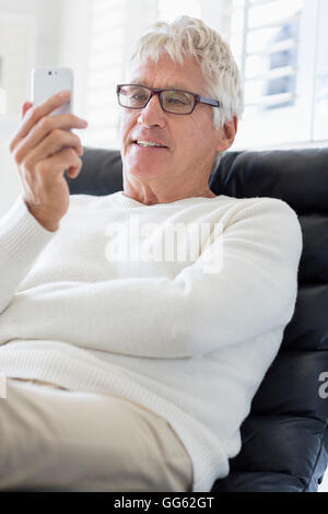 Happy senior man using a mobile phone Stock Photo