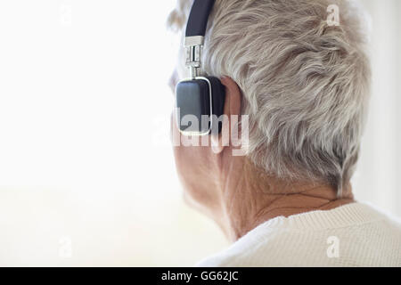 Senior man listening to music on headphones Stock Photo