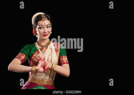 Young woman performing Bharatanatyam over black background Stock Photo