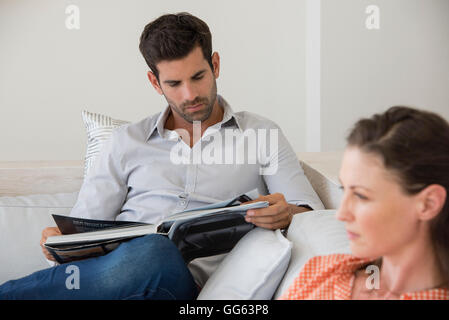 Man reading a magazine Stock Photo