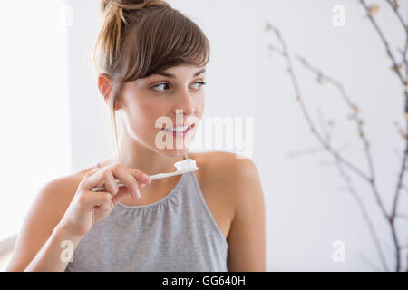 Close-up of a young beautiful woman brushing her teeth Stock Photo
