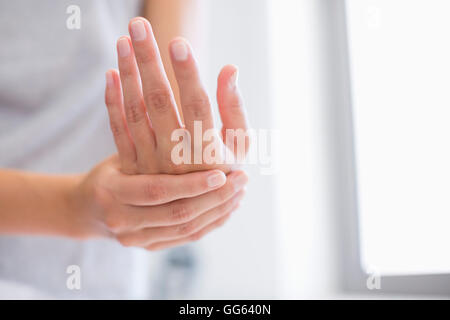 Close-up of a woman applying moisturizer on her hands Stock Photo