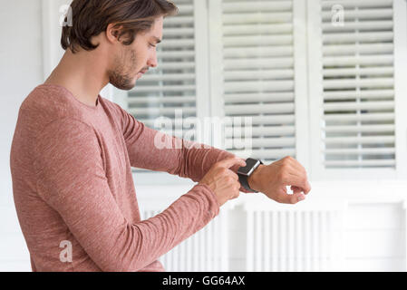 Young man using his smart watch Stock Photo