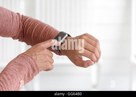 Young man using his smart watch Stock Photo