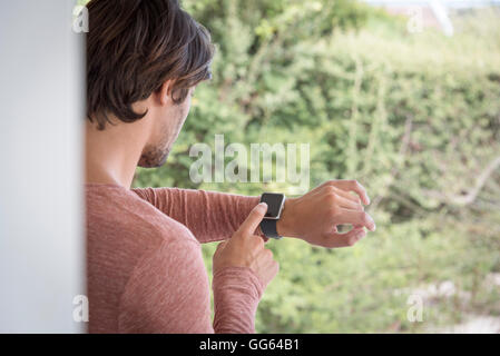 Young man using his smart watch Stock Photo