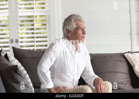 Happy senior man sitting at home Stock Photo
