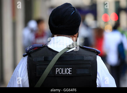 An armed Sikh police officer patrols as part of a security operation near the junction of Knightsbridge and Hyde Park Corner, London, as Scotland Yard announced that the first of 600 additional armed officers were trained and operationally ready, and unveiled plans to put more marksmen on public patrol. Stock Photo