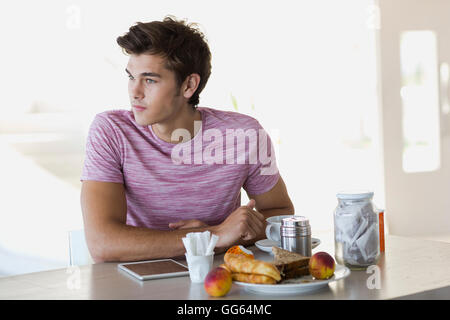Close-up of a young man having breakfast Stock Photo