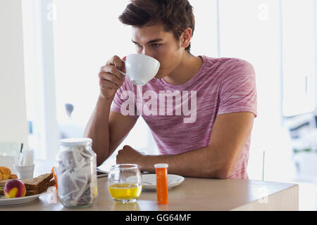 Close-up of an attractive young man drinking coffee Stock Photo
