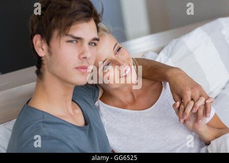 Happy young couple relaxing on the bed Stock Photo