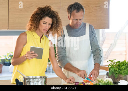 Couple preparing food in the kitchen Stock Photo