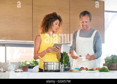 Couple preparing food in the kitchen Stock Photo