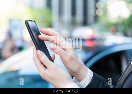 Businesswoman using a smartphone Stock Photo