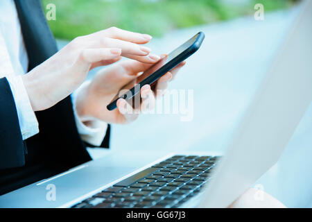 Businesswoman using a smartphone Stock Photo