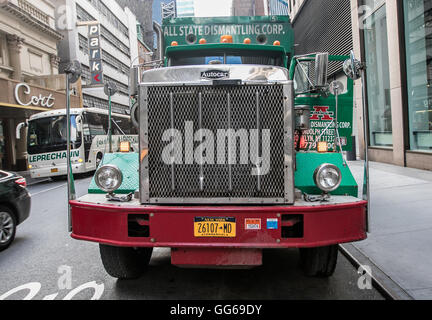 Large green garbage truck parked in the streets of Manhattan. Stock Photo