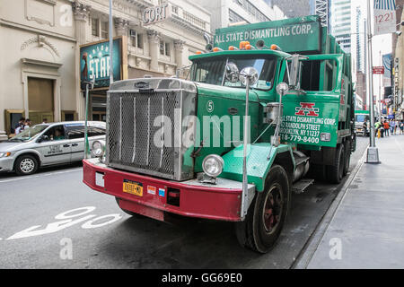 Large green garbage truck parked in the streets of Manhattan. Stock Photo