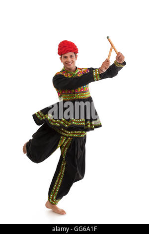 Male dandiya dancer dancing with sticks Stock Photo - Alamy