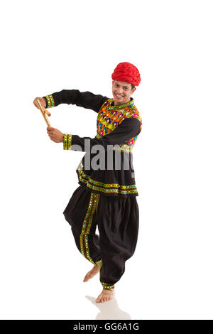 Male dandiya dancer dancing with sticks Stock Photo - Alamy