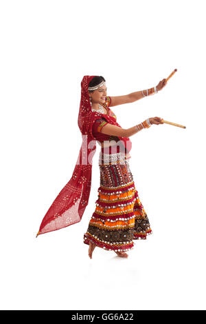 Female dandiya dancer dancing with sticks Stock Photo - Alamy